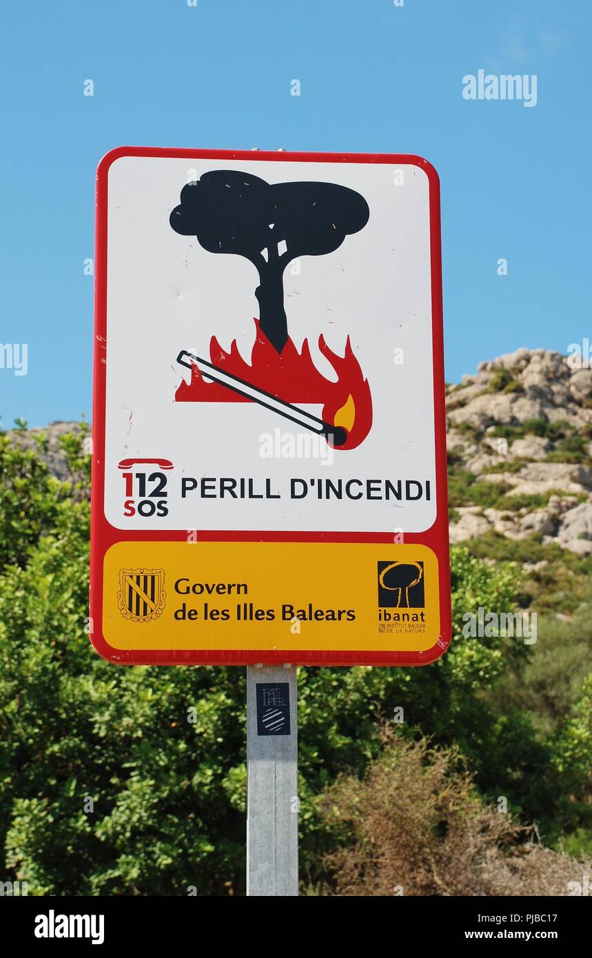 A Government sign warning of fire risk by the Tramuntana mountains at Puerto Pollensa on the Spanish island of Majorca on September 5, 2017. Stock Photo