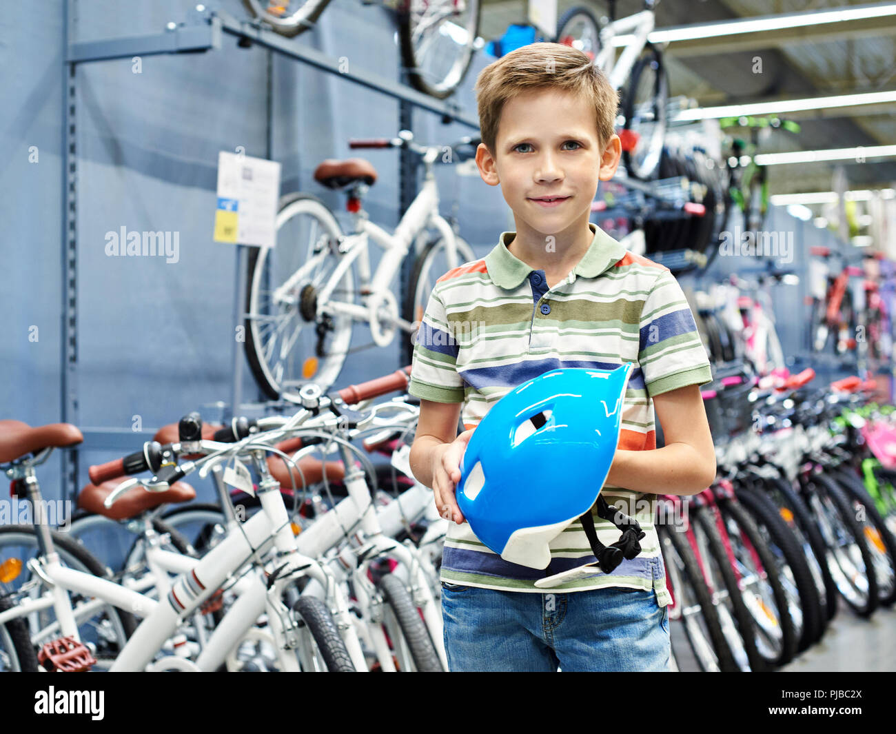 Boy with a protective sports helmet for cycling in the store Stock Photo