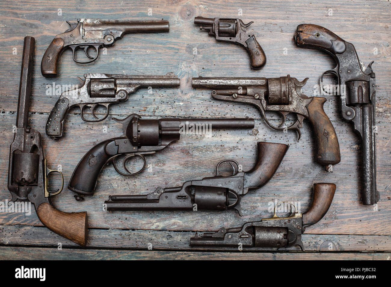 High resolution image of historical guns and pistols on a vintage wood