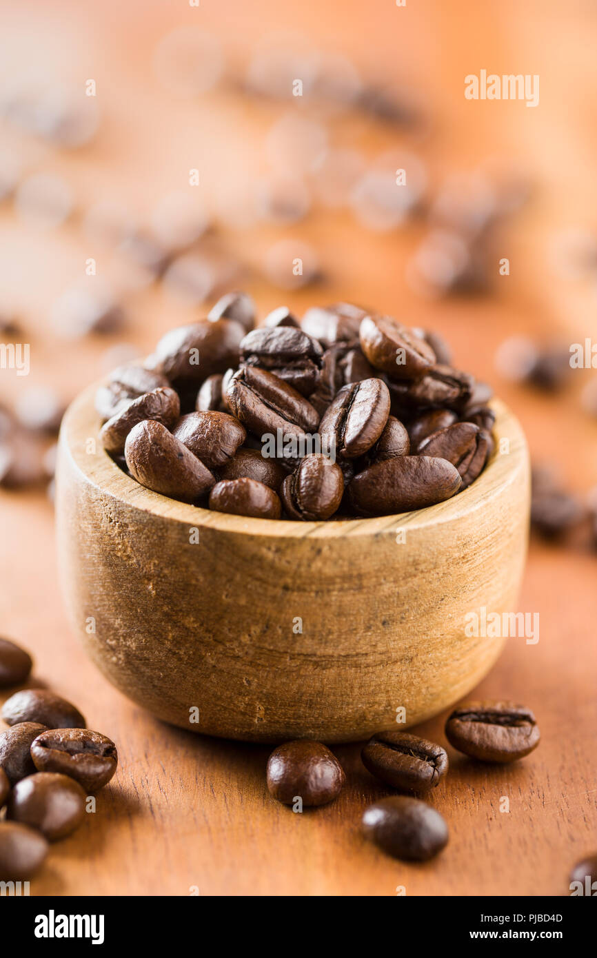 Roasted coffee beans in wooden bowl Stock Photo - Alamy