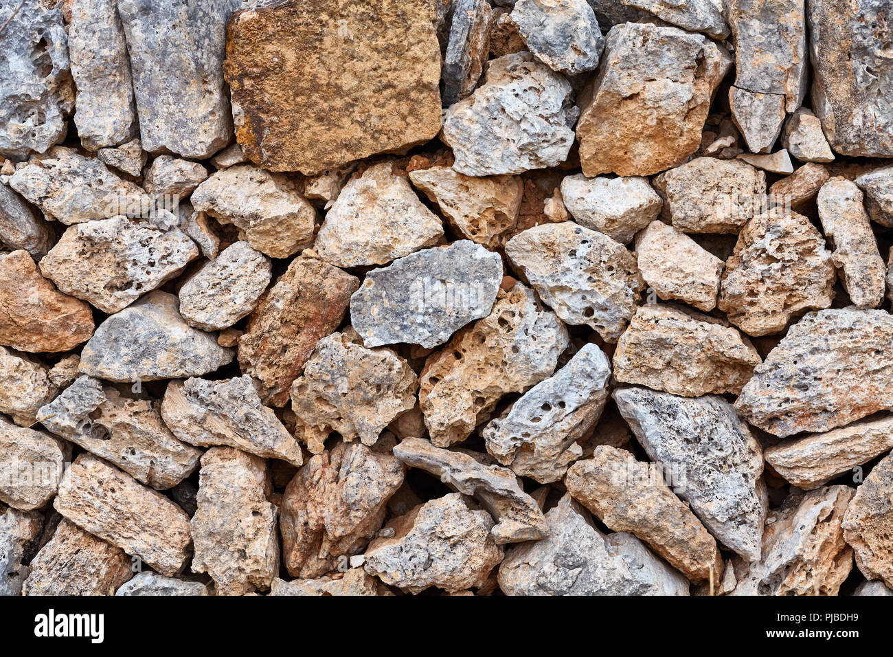 Old wall made of volcanic rough rocks, natural background or texture. Stock Photo