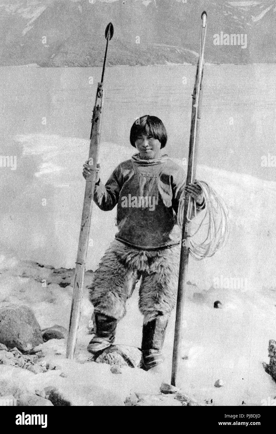A 1920 portrait of a young Inuit / Eskimo in the Arctic with harpoon