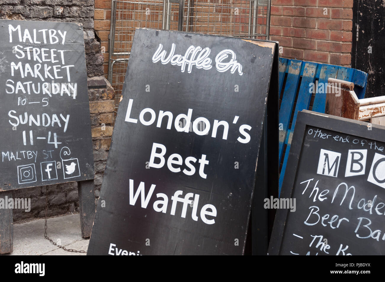 Advertisement blackboards at the entrance to Maltby Street Market, London, England, UK Stock Photo