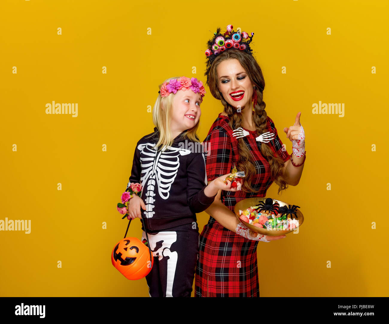 Colorful halloween. smiling modern mother and child in Mexican style