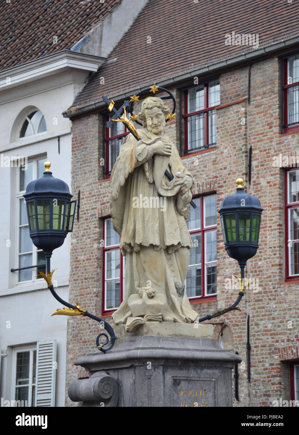 St. John of Nepomuk, John Nepomucene statue on bridge with tower of Church of Our Lady Stock Photo