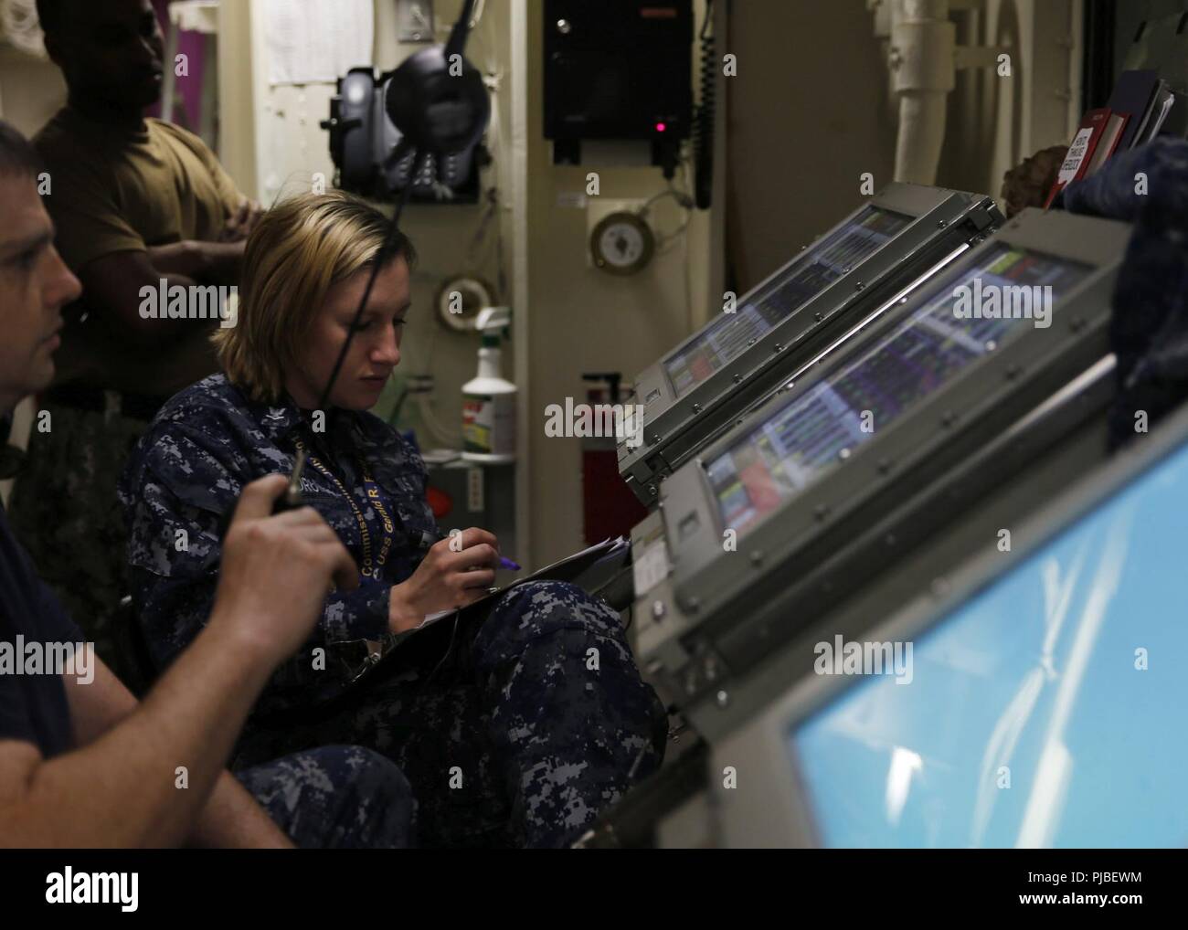 NORFOLK, Va. (July 11, 2018)  Aviation Boatswain's Mate (Fuel) 3rd Class Autumn Landrum, from Oliver Springs, Tennessee, assigned to USS Gerald R. Ford's (CVN 78) air department, logs fuel tank gallons and start times during a fuel offload. Ford is currently preparing to enter the shipyards for post shake down availability in Newport News, Virginia. Stock Photo