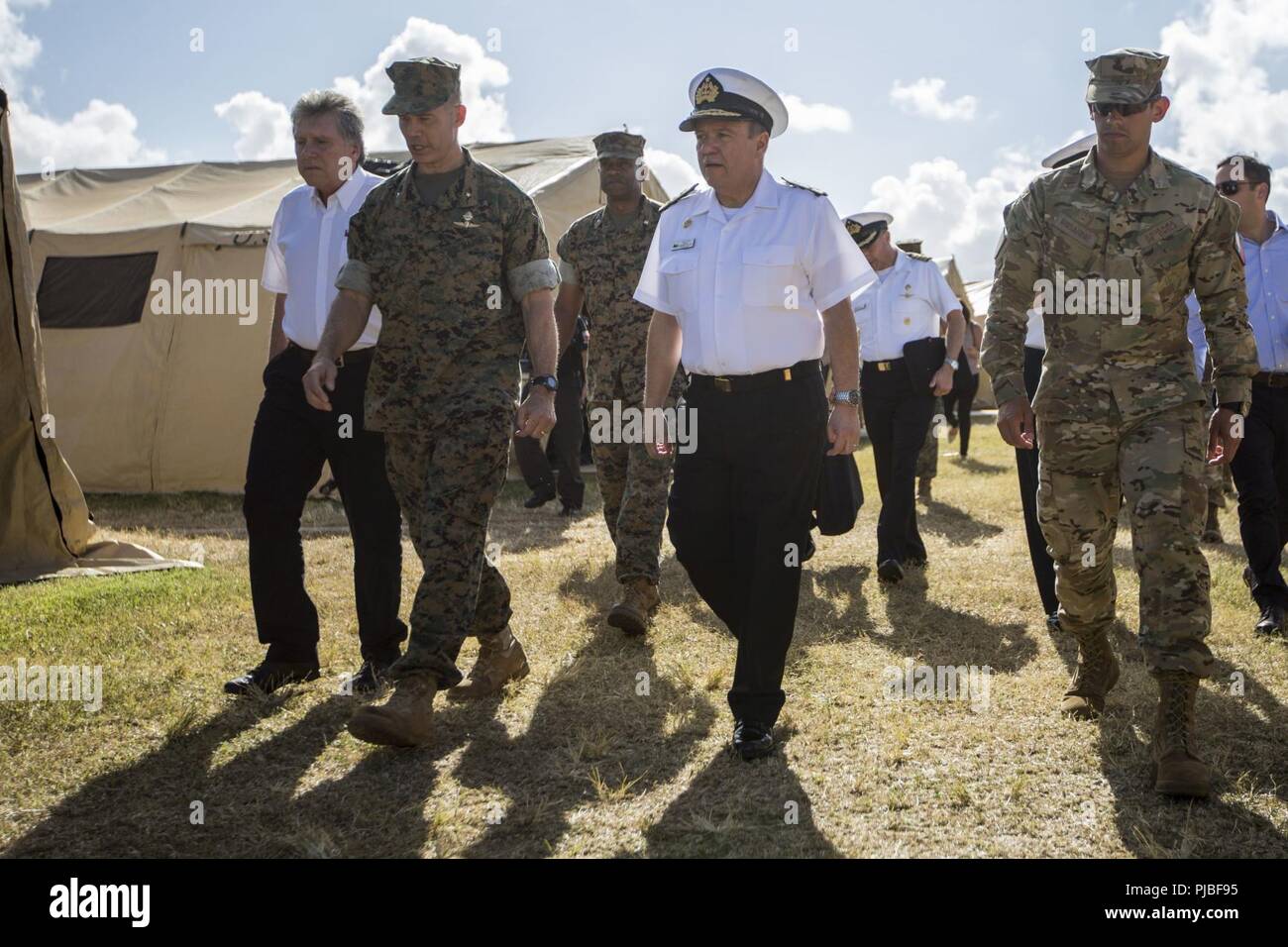 MARINE CORPS BASE HAWAII (July 11, 2018) Alberto Espina, Chilean Minister of Defense, U.S. Marine Corps Brig. Gen. Mark Hashimoto, component commander, Fleet Marine Force, and Chilean Navy Adm. Julio Leiva, Chilean Navy Commander-in-Chief, explore tent city during the Rim of the Pacific (RIMPAC) exercise on Marine Corps Base Hawaii July 11, 2018. RIMPAC provides high-value training for task-organized, highly capable Marine Air-Ground Task Force and enhances the critical crisis response capability of U.S. Marines in the Pacific. Marines in the Pacific. Twenty-five nations, 46 ships, five submar Stock Photo