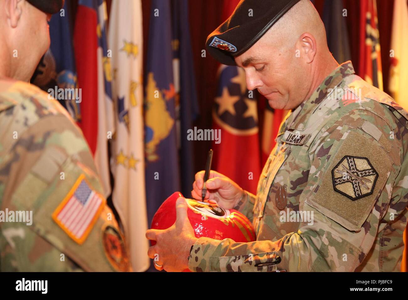 Command Sgt. Maj. Will Holland colors in the eye of a Japanese “Daruma” doll to symbolize the achievement of his goals as part of his relinquishment of responsibility ceremony July 11, 2018, at the Camp Zama Community Club. Holland is headed to Washington, D.C., to serve as a liaison between the U.S. Army and the U.S. Department of Education. Stock Photo