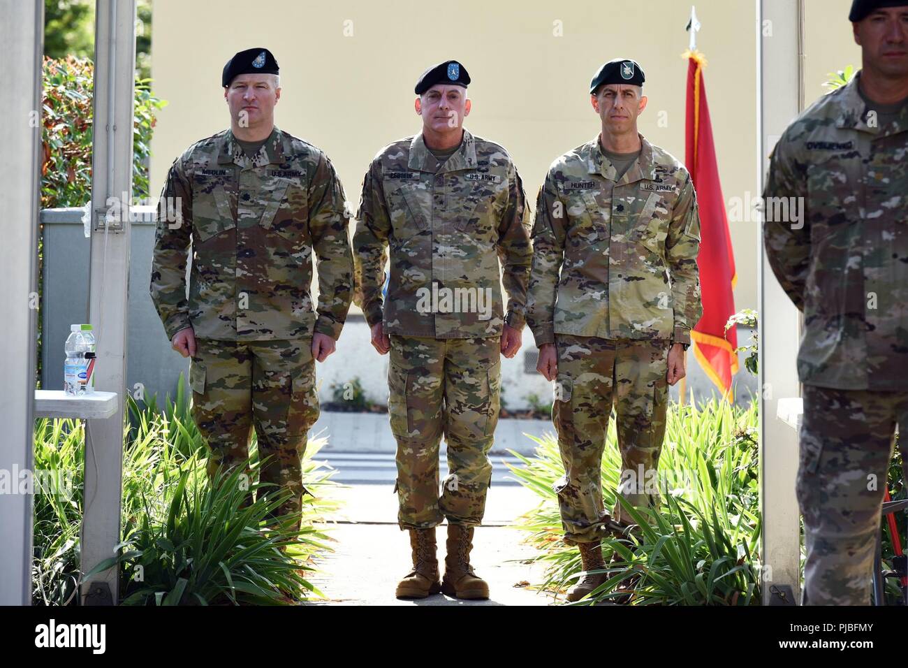 U.S. Army Africa, Brig. Gen. Eugene J. LeBoeuf, the U.S. Army Africa acting commanding general (center), Lt. Col. Marcus S. Hunter, Incoming Battalion Commander, Headquarters and Headquarters Battalion, U.S. Army Africa (left) and Lt. Col. Brett M. Medlin, outgoing Battalion Commander, Headquarters and Headquarters Battalion (right), during the change of command ceremony at Caserma Ederle in Vicenza, Italy, July 12, 2018. Stock Photo