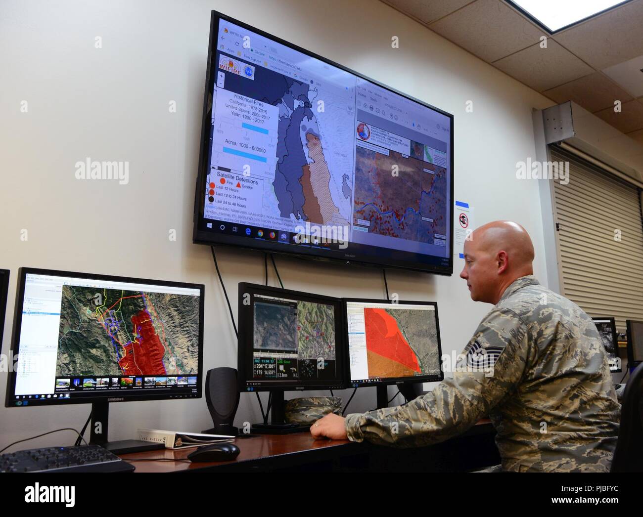 Tech. Sgt. Peter Radosevich, 234th Intelligence Squadron imagery mission supervisor, coordinates full-motion video analysis for the Klamathon Fire July 11, 2018, at Beale Air Force Base, California. The imagery analysts coordinate with crews on the ground, which allow them to fight the fires more effectively. They notify the crews on the ground if the fire has gotten past barriers created by bulldozers or if new fires have been started by embers. During emergencies, they often conduct 24-hour operations until the situation is under control. Stock Photo