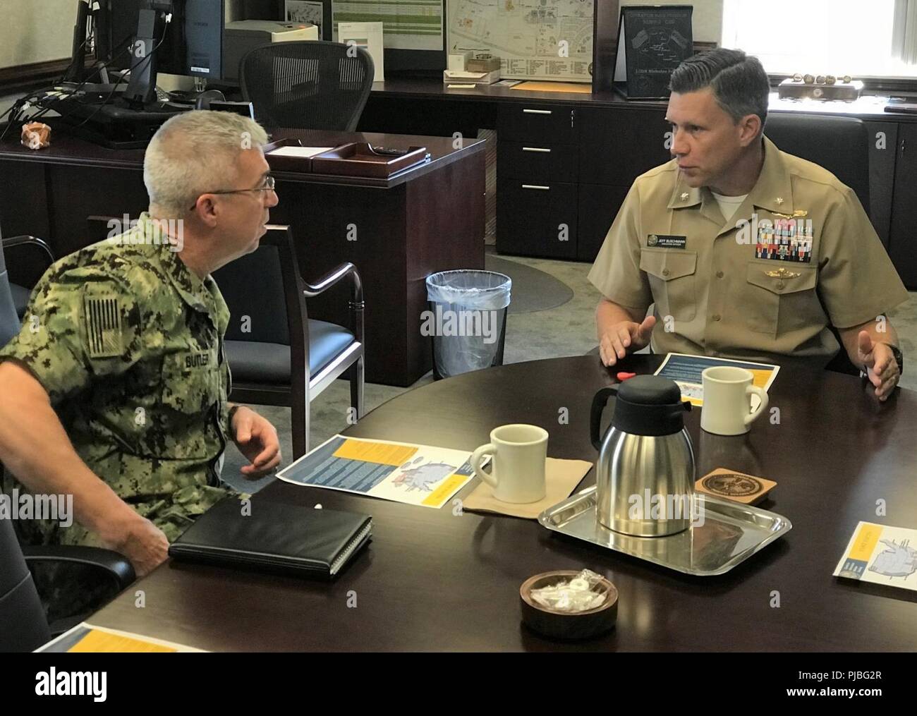 Fla. (July 12, 2018) Rear Adm. James M. Butler (left), deputy commander, U.S. Fleet Cyber Command/U.S. 10th Fleet, met with the Center for Information Warfare Training's (CIWT) Executive Officer Cmdr. Jeffrey Buschmann and other CIWT leaders to learn more about the CIWT domain. While visiting, Butler also toured Information Warfare Training Command  Corry Station courses and met with students. Stock Photo