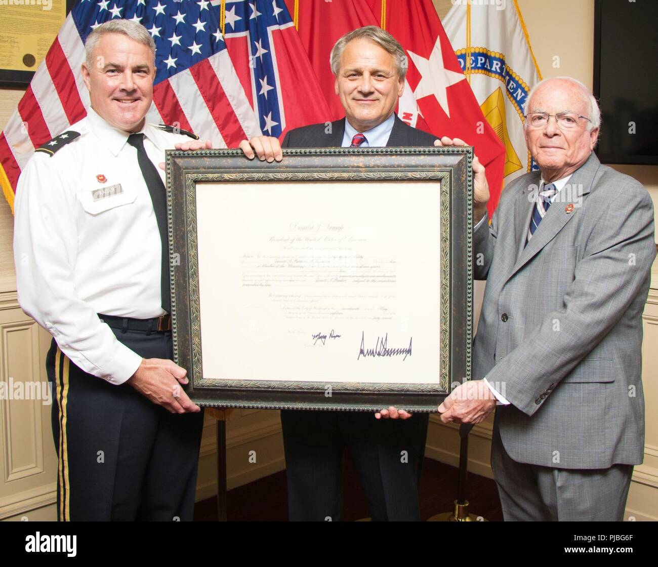 Mississippi River Commission President Maj. Gen. Richard Kaiser and MRC member Sam Angel present an appointment letter to James A. Reeder at the MRC headquarters in Vicksburg, Miss., July 11, 2018. President Donald Trump appointed Reeder as a member of the Mississippi River Commission May 17, 2018. Commission appointments are nominated by the President of the United States and vetted by the U.S. Senate. (USACE Stock Photo