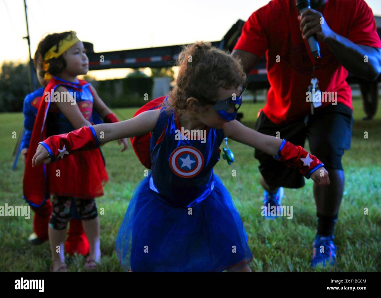 'Miss Captain America' takes a bow after being crowned best children's costume during Freedom Fest, July 3, 2018, at Grand Forks Air Force Base, North Dakota. Attendees were encouraged to wear their best patriotic costumes during the event held to celebrate America's 242nd birthday. Stock Photo