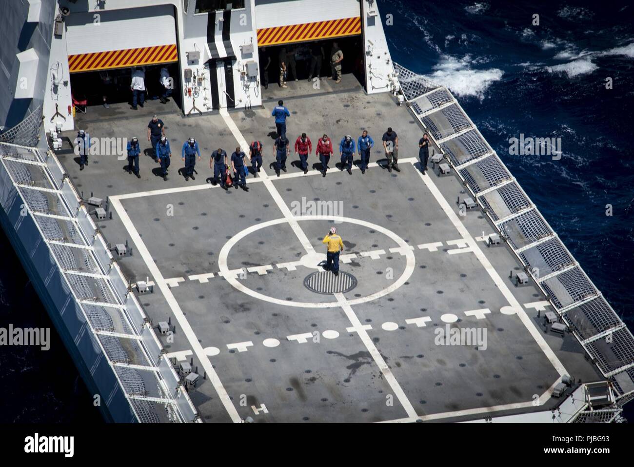 PACIFIC OCEAN (July 11, 2018) The crew of U.S. Coast Guard Cutter Bertholf (WMSL 750) inspects the flight deck prior to a medical evacuation exercise in during Rim of the Pacific (RIMPAC) exercise. Twenty-five nations, more than 46 ships and 5 submarines, about 200 aircraft and 25,000 personnel are participating in RIMPAC from June 27 to Aug. 2 in and around the Hawaiian Island and Southern California.  The world’s largest international maritime exercise, RIMPAC provides a unique training opportunity while fostering and sustaining cooperative relationships among participants critical to ensuri Stock Photo