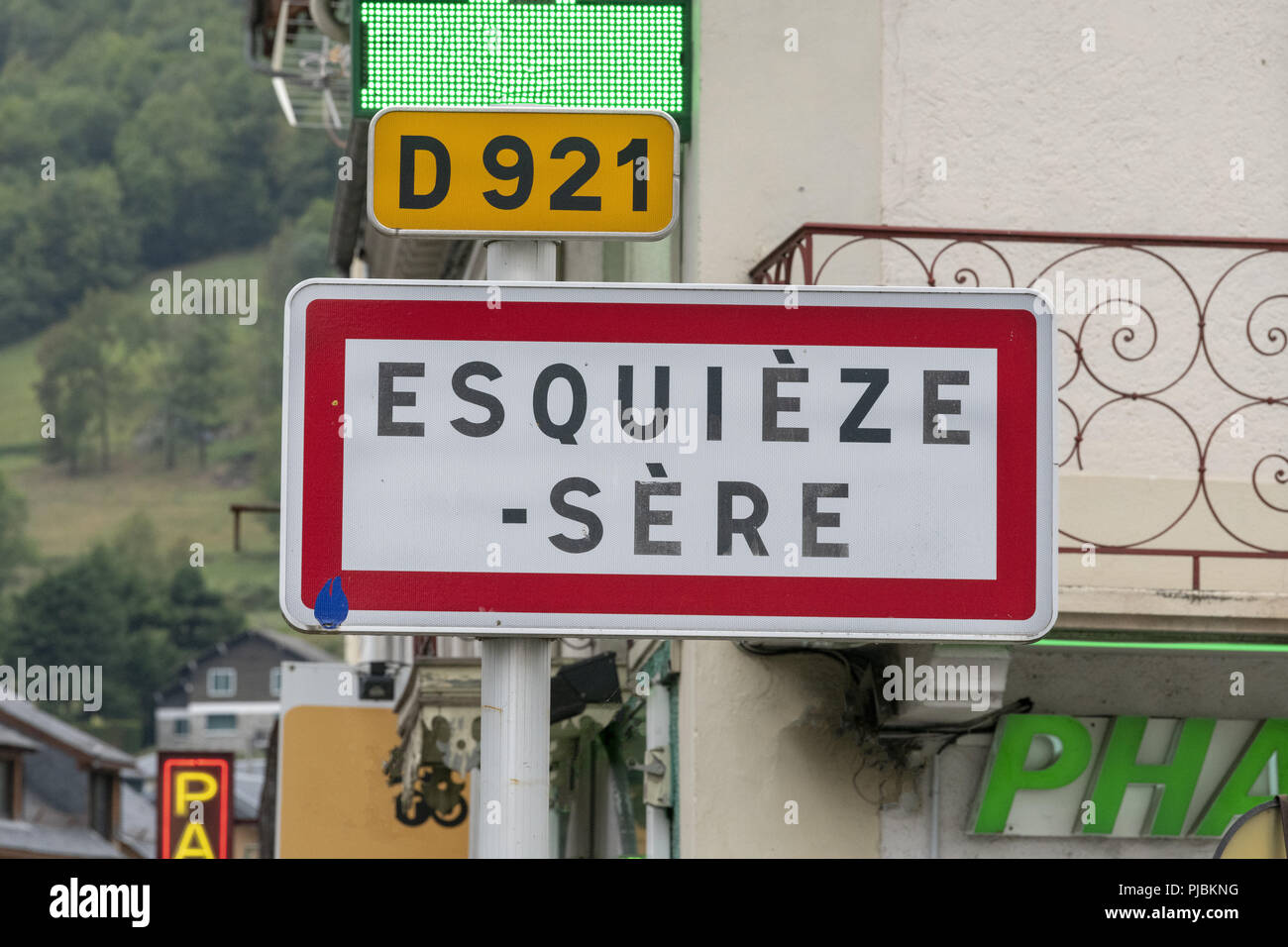French village name signs, also showing direction to the departmental road N° 921.  Les Pyrénées, Tourist spot, and Tour de France stop.    -        . Stock Photo