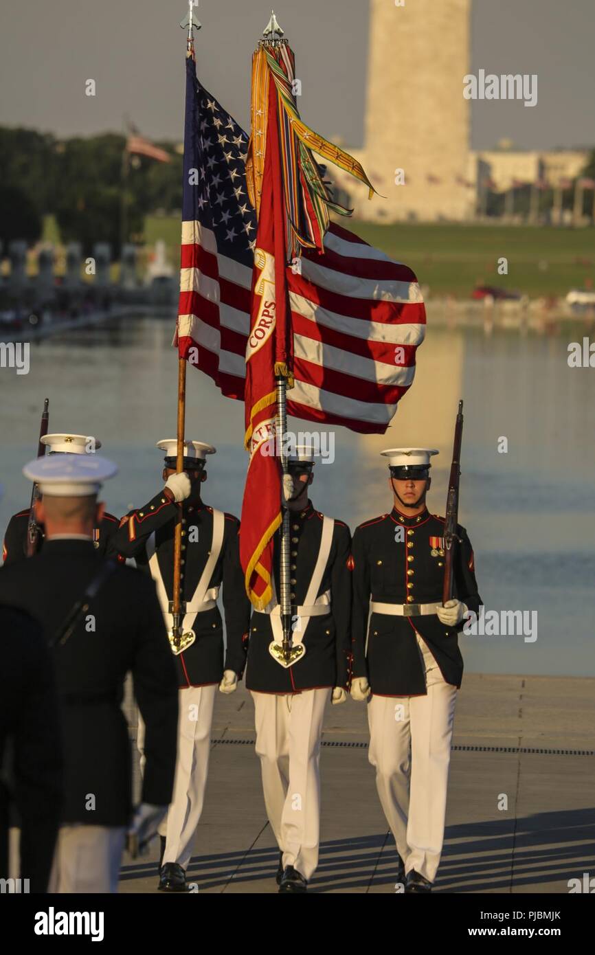 Marines with the U.S. Marine Corps Color Guard march with the National Ensign and U.S. Marine Corps Battle Colors during a Tuesday Sunset Parade at the Lincoln Memorial, Washington D.C., July 10, 2018. The guest of honor for the parade was the former Vice President of the U.S., Joe Biden, and the hosting official was the Staff Judge Advocate to the Commandant of the Marine Corps, Maj. Gen. John R. Ewers Jr. Stock Photo
