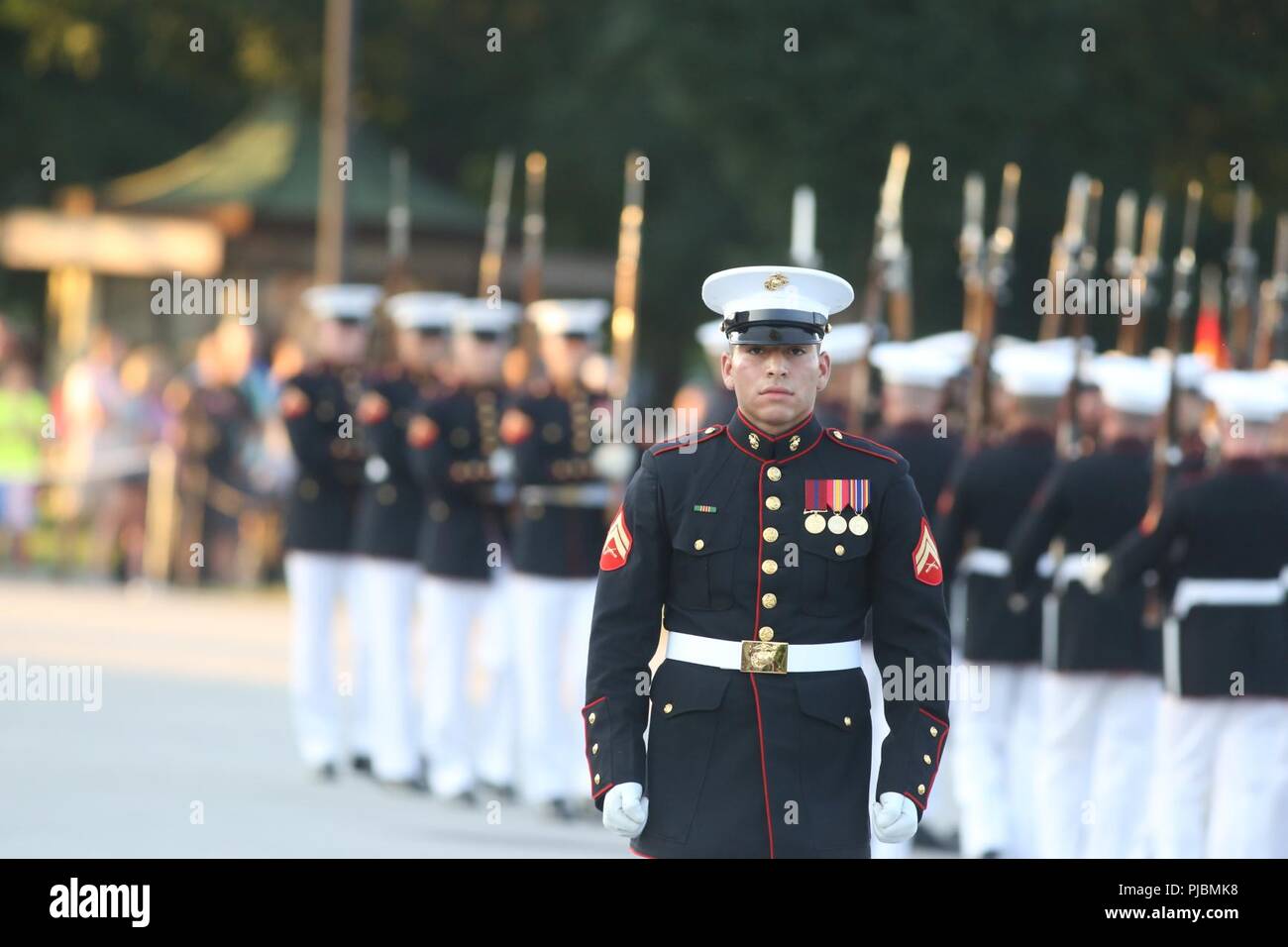 Corporal Christopher Ochoa, rifle inspector, U.S. Marine Corps Silent Drill Platoon, marches across the parade deck during a Tuesday Sunset Parade at the Lincoln Memorial, Washington D.C., July 10, 2018. The guest of honor for the parade was the former Vice President of the U.S., Joe Biden, and the hosting official was the Staff Judge Advocate to the Commandant of the Marine Corps, Maj. Gen. John R. Ewers Jr. Stock Photo