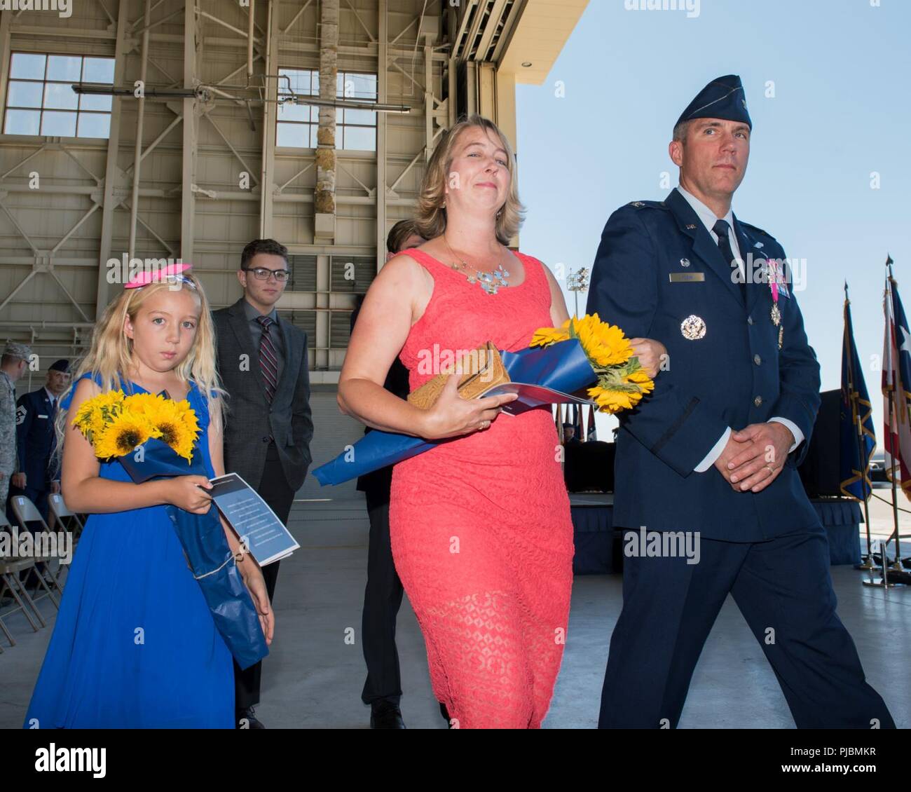 U.S. Air Force Col. John Klein, 60th Air Mobility Wing outgoing commander and his family depart after the Change of Command Ceremony at Travis Air Force Base, Calif., July 10, 2018. Col. Ethan Griffin received command of Air Mobility Command’s largest wing from Klein. Stock Photo