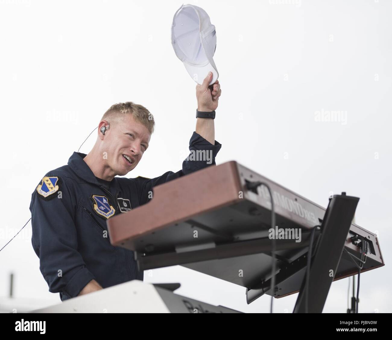 Master Sgt. Jonathan McPherson, U.S. Air Force Band Max Impact keyboardist, tips his hat to the crowd during a performance at Daytona International Speedway in Daytona Beach, Fla., July 6, 2018. Max Impact performed for the Coca-Cola Firecracker 250 and the Coke Zero Sugar 400, showcasing Air Force excellence to tens of thousands of attendees. Stock Photo