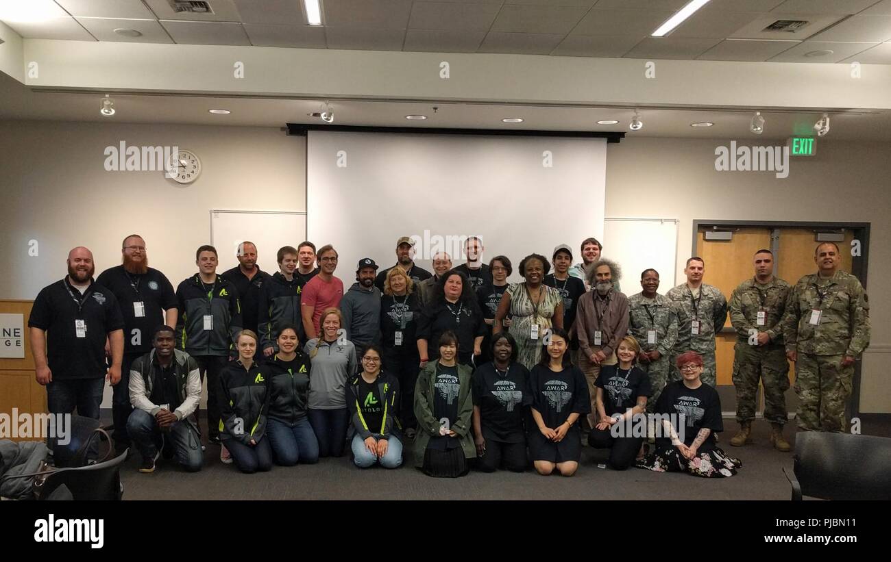 Soldiers from 56th Theater Information Operations Group, Joint Force Headquarters, and Headquarters and Headquarters Company, 181st Brigade Support Battalion, 81st Stryker Brigade Combat Team, pose with participants of International Collegiate Cyber Defense Invitational, July 6th, 2018, at Highline Community College in Des Moines, Wash. Washington National Guard soldiers attended the ICCDI to help educate information technology students on their responses to cyber-attacks. (Washington Army National Guard Stock Photo