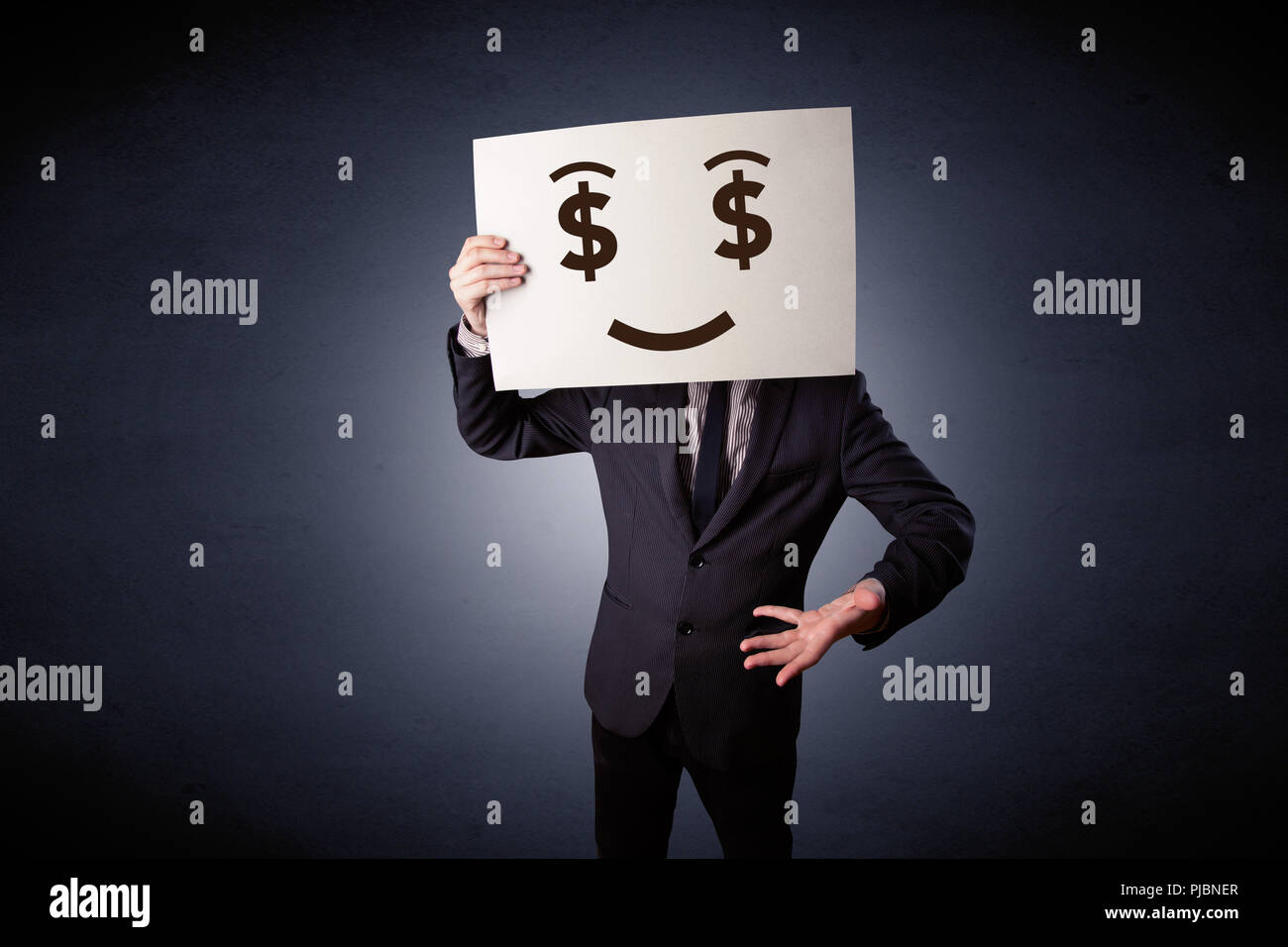 Young casual businessman hiding behind a greedy face drawing on ...