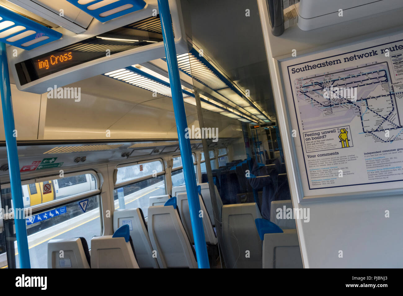 inside of a railway train commuter southeastern coach with train route map and seating standard class. Stock Photo