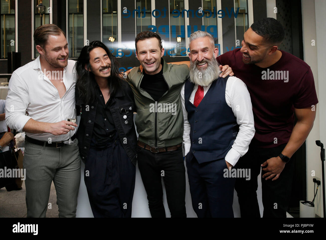 EDITORIAL USE ONLY: (Left to right) Philips ambassadors Ben Heath, Karlmond Tang, Harry Judd, Nigel Card and Marcus Bronzy attend the Philips &Ocirc;Many Faces&Otilde; exhibition that features portrait artwork from Guglielmo Alfarone, which celebrates the multi-dimensional nature of the modern man at the Mayfair Gallery, London. Stock Photo