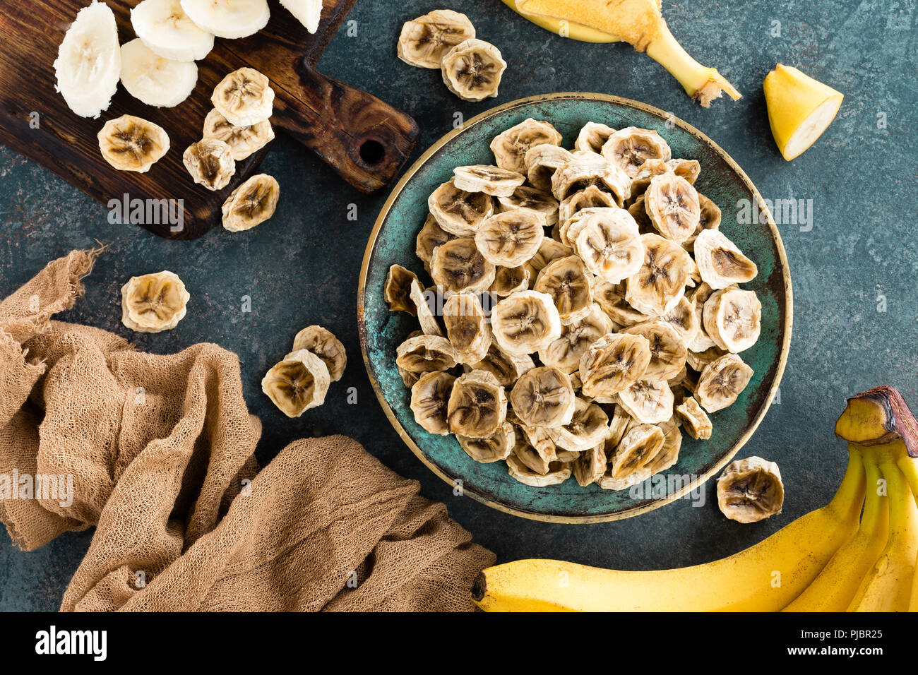 Dried banana chips and fresh bananas Stock Photo Alamy