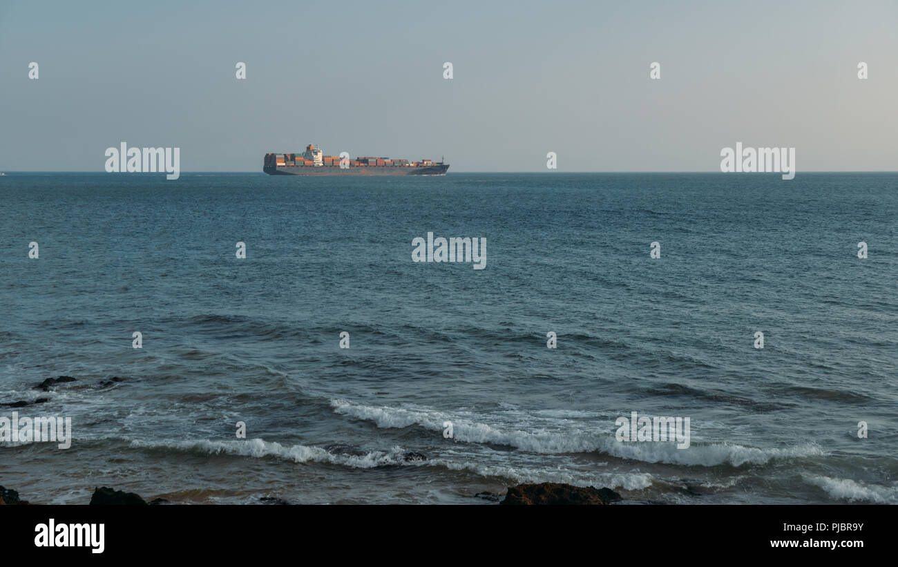 A large, ocean-going oil tanker ship as seen from the coast. Stock Photo