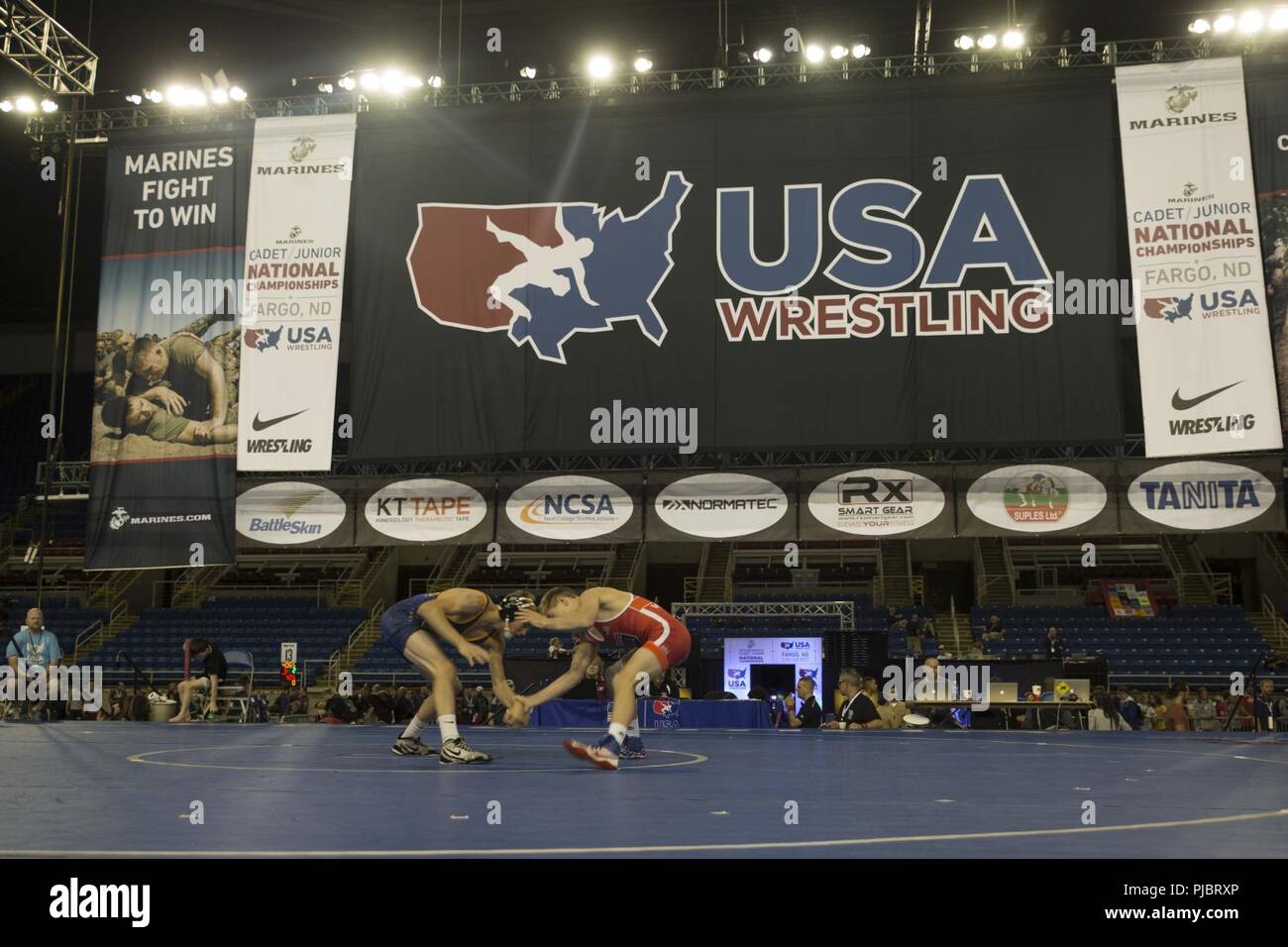 Keegan Slyter, a wrestler from Olathe North High School in Olathe, Kansas, and Khyler Brewer, a wrestler from Kansas City, Missouri, start their match against each other during the 2018 U.S. Marine Corps Freestyle Finals in Fargo, North Dakota, July 15. The Freestyle Finals feature more than 30 top-level athletes from across the country. By partnering with USA Wrestling, the national governing body for the sport in America, the Marine Corps will reach a broad cross-section of high school and collegiate-aged club wrestlers as well as an ever-growing influencer network of coaches, referees, wres Stock Photo