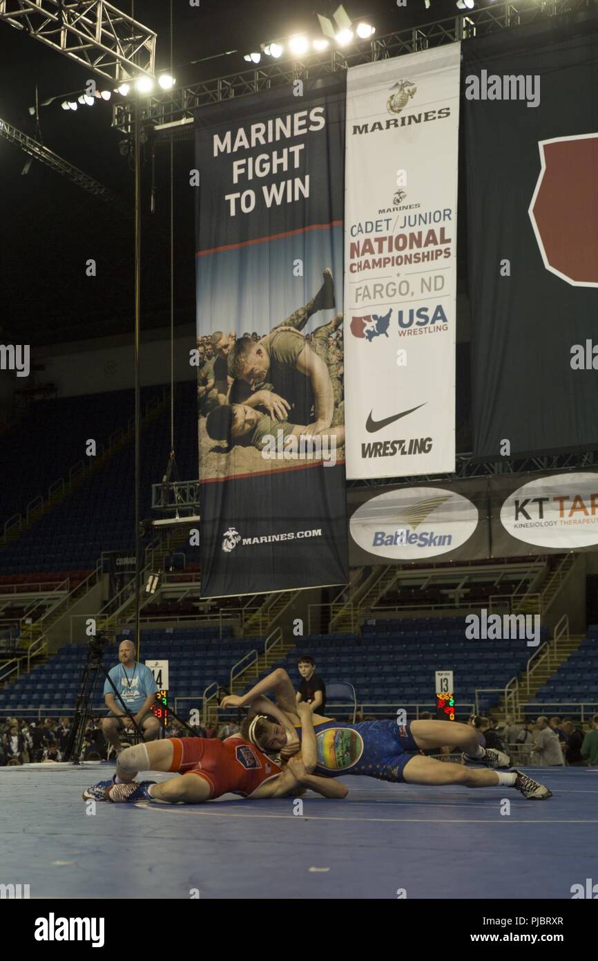 Khyler Brewer (red), a wrestler from Kansas City, Missouri, grapples Keegan Slyter, a wrestler from Olathe North High School in Olathe, Kansas, during the 2018 U.S. Marine Corps Freestyle Finals in Fargo, North Dakota, July 15. The Freestyle Finals feature more than 30 top-level athletes from across the country. By partnering with USA Wrestling, the national governing body for the sport in America, the Marine Corps will reach a broad cross-section of high school and collegiate-aged club wrestlers as well as an ever-growing influencer network of coaches, referees, wrestling alumni and parents. Stock Photo
