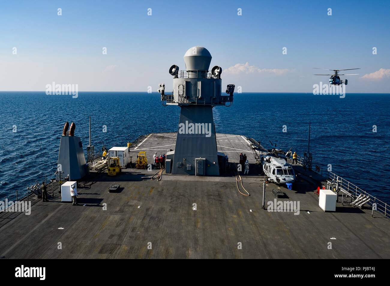 BLACK SEA (July 11, 2018) A Ukrainian Ka-27 helicopter prepares to land aboard the Blue Ridge-class command and control ship USS Mount Whitney (LCC 20) in the Black Sea during exercise Sea Breeze 2018, July 11. Sea Breeze is a U.S. and Ukraine co-hosted multinational maritime exercise held in the Black Sea and is designed to enhance interoperability of participating nations and strengthen Maritime security within the region. Stock Photo