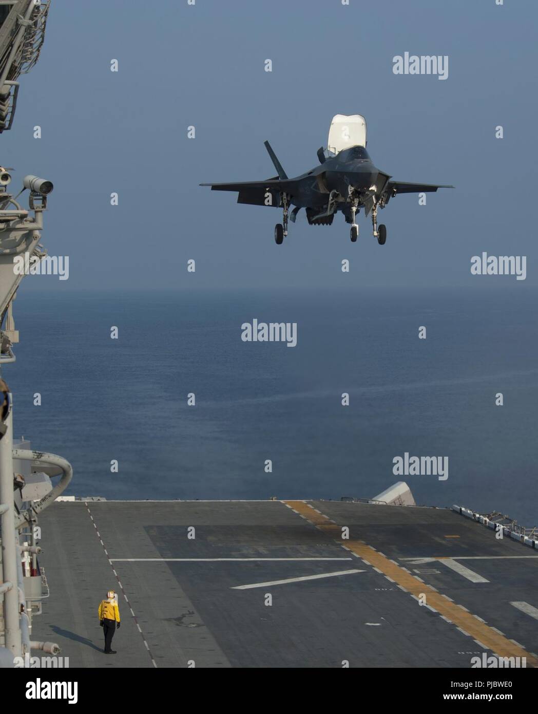 PACIFIC OCEAN (July 17, 2018) An F-35B Lightning II aircraft assigned to Marine Fighter Attack Squadron 121(VMMFA 121) lands on the flight deck of the amphibious assault ship USS Wasp (LHD 1) during carrier qualifications and flight deck certifications. VMFA-121 is aboard Wasp assigned under the 31st Marine Expeditionary Unit forward deployed to Okinawa, Japan. Stock Photo