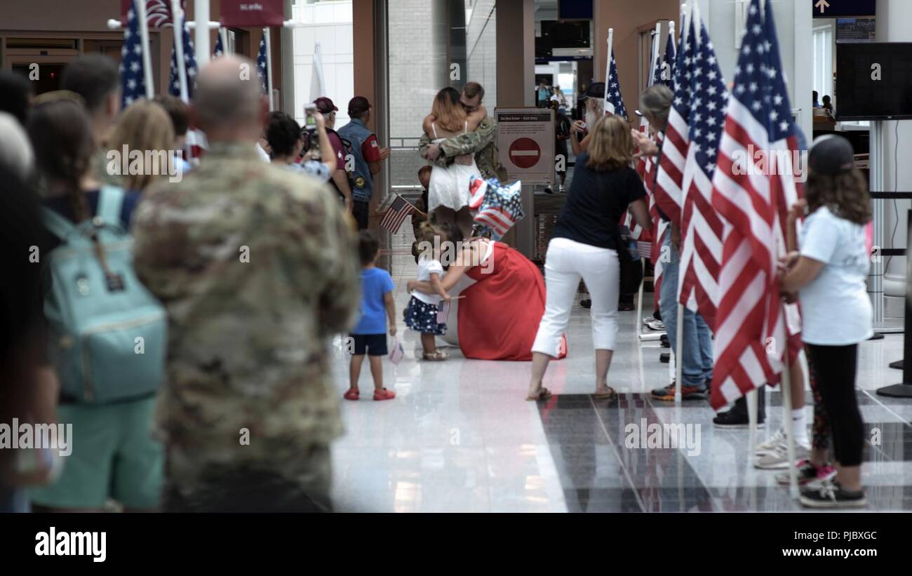 U.S. Soldiers from the South Carolina Army National Guard’s 1-151 Attack Reconnaissance Battalion and Det 1, Company B, 2-238 General Support Aviation Battalion arrive home to Columbia, South Carolina, July 13, 2018 after their nearly yearlong deployment with the 3rd Combat Aviation Brigade in Afghanistan. Stock Photo