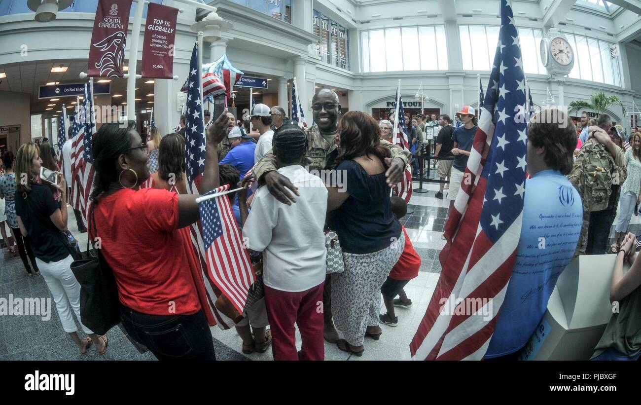 U.S. Soldiers from the South Carolina Army National Guard’s 1-151 Attack Reconnaissance Battalion and Det 1, Company B, 2-238 General Support Aviation Battalion arrive home to Columbia, South Carolina, July 13, 2018 after their nearly yearlong deployment with the 3rd Combat Aviation Brigade in Afghanistan. Stock Photo