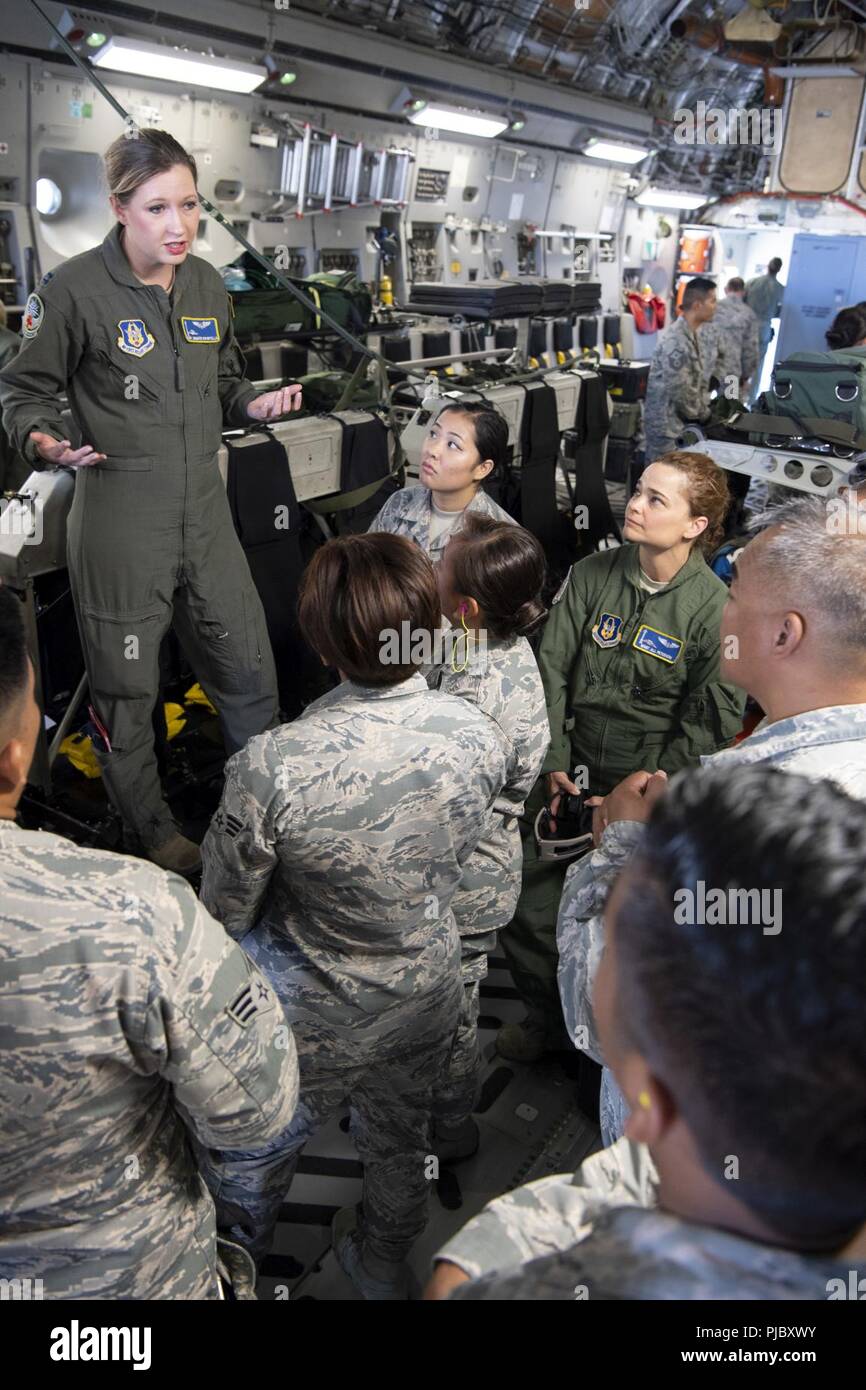 U.S. Air Force Capt. Jennifer Riportella, a flight nurse with the 446th Aeromedical Evacuation Squadron, discusses patient transport equipment used aboard a U.S. Air Force C-17 Globemaster III aircraft with 624th Aeromedical Staging Squadron personnel at U.S. Coast Guard Air Station Barbers Point, Hawaii, July 10, 2018, during Pacific Lifeline 2018. Pacific Lifeline 2018 is a statewide medical exercise in Hawaii conducted as part of a larger 2018 Rim of the Pacific Exercise. The 624th ASTS provides medical support for the 624th Regional Support Group, ensuring oversight of individual health an Stock Photo