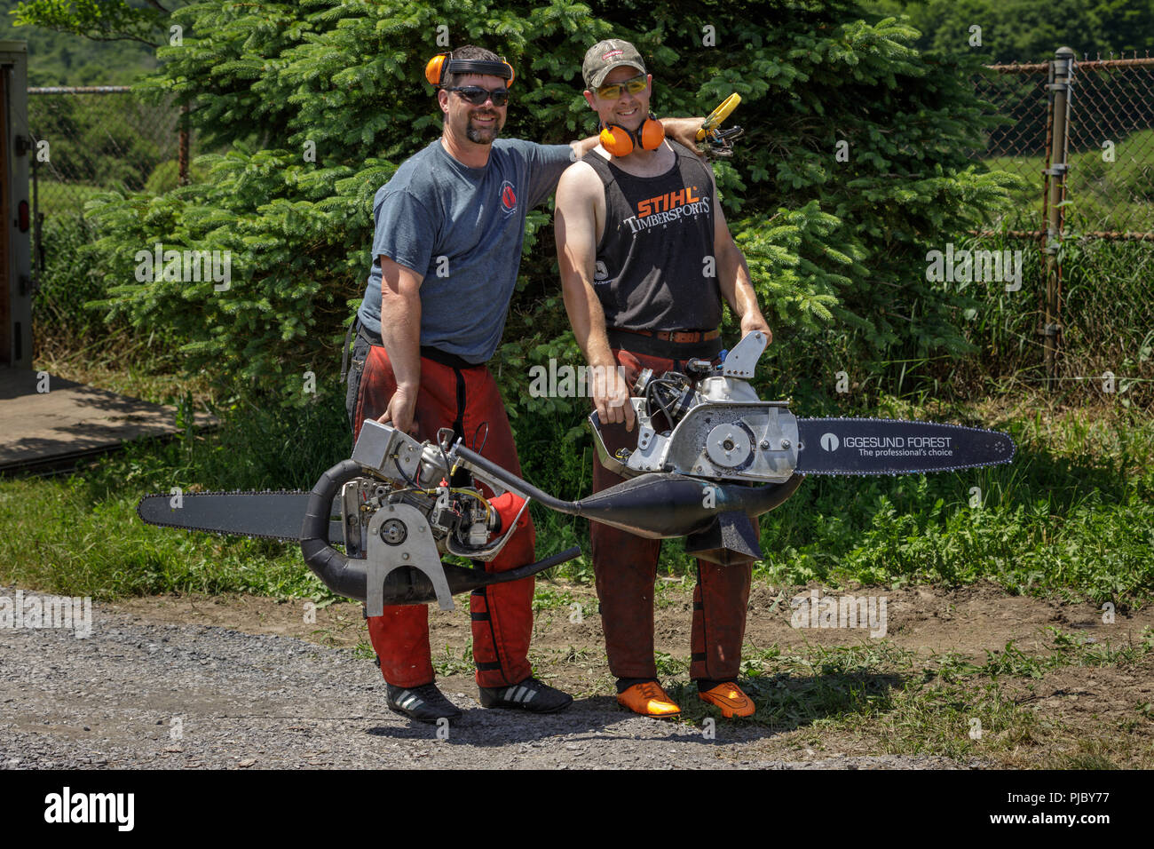 Two men pose with their 'hot saws', Cherry Valley Outdoor Games, Otsego County, New York State. Stock Photo