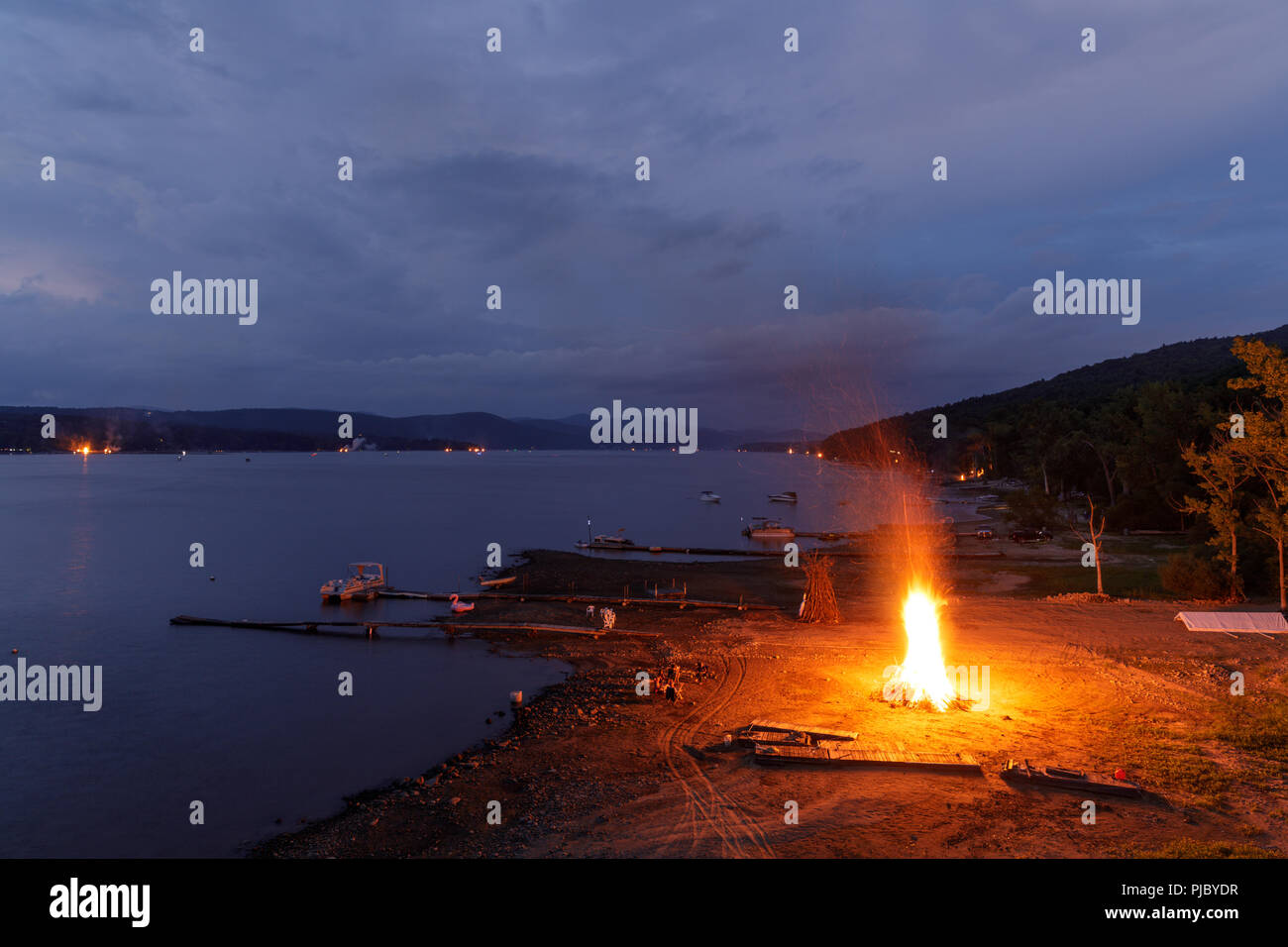 Summer ends with a 'Ring of Fire' on Labor Day weekend, bonfires lit along the shores of Great Sacandaga Lake, southern Adirondacks, New York State. Stock Photo