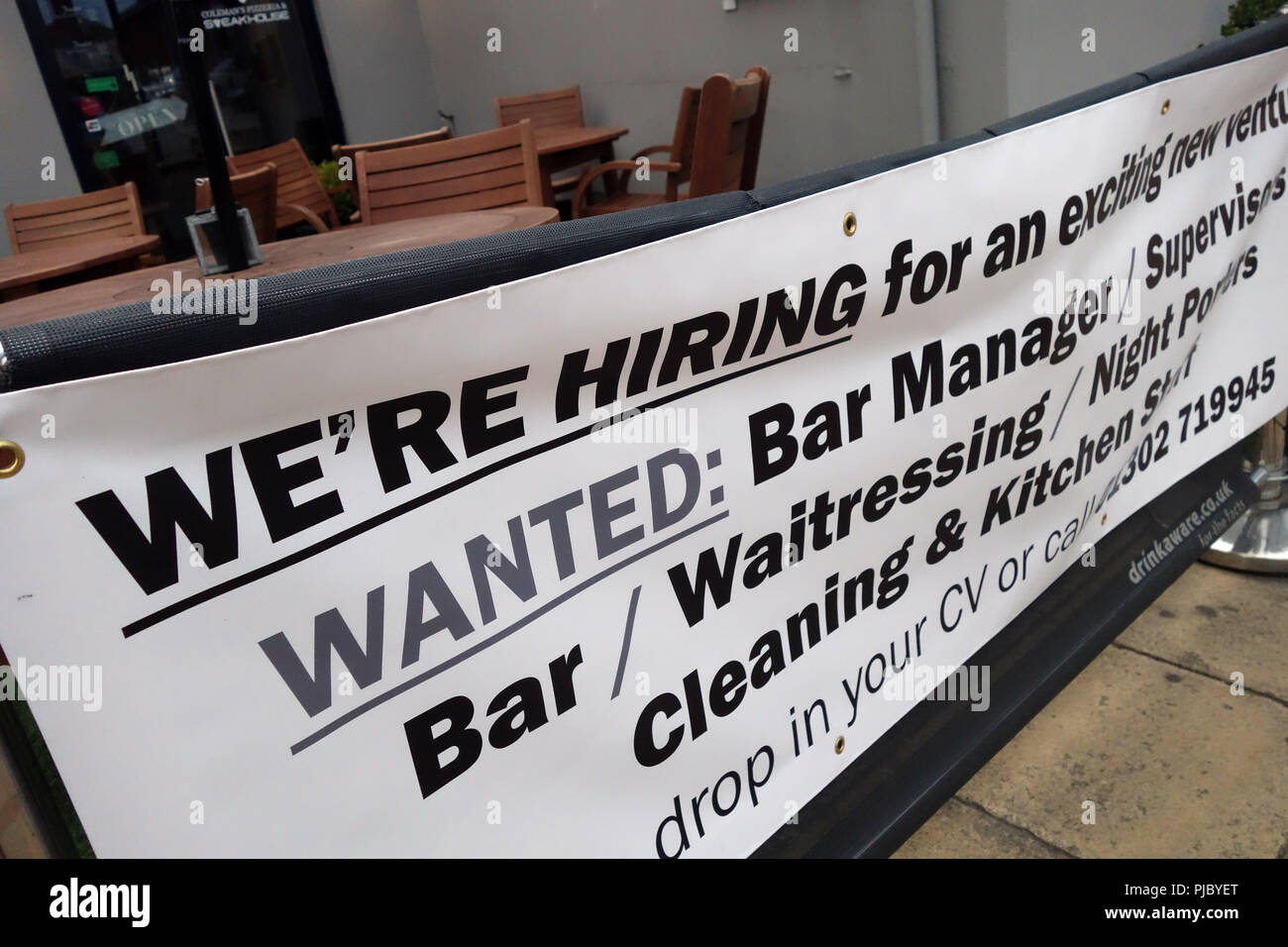 We're Hiring sign outside a wine bar in Bawtry, England Stock Photo