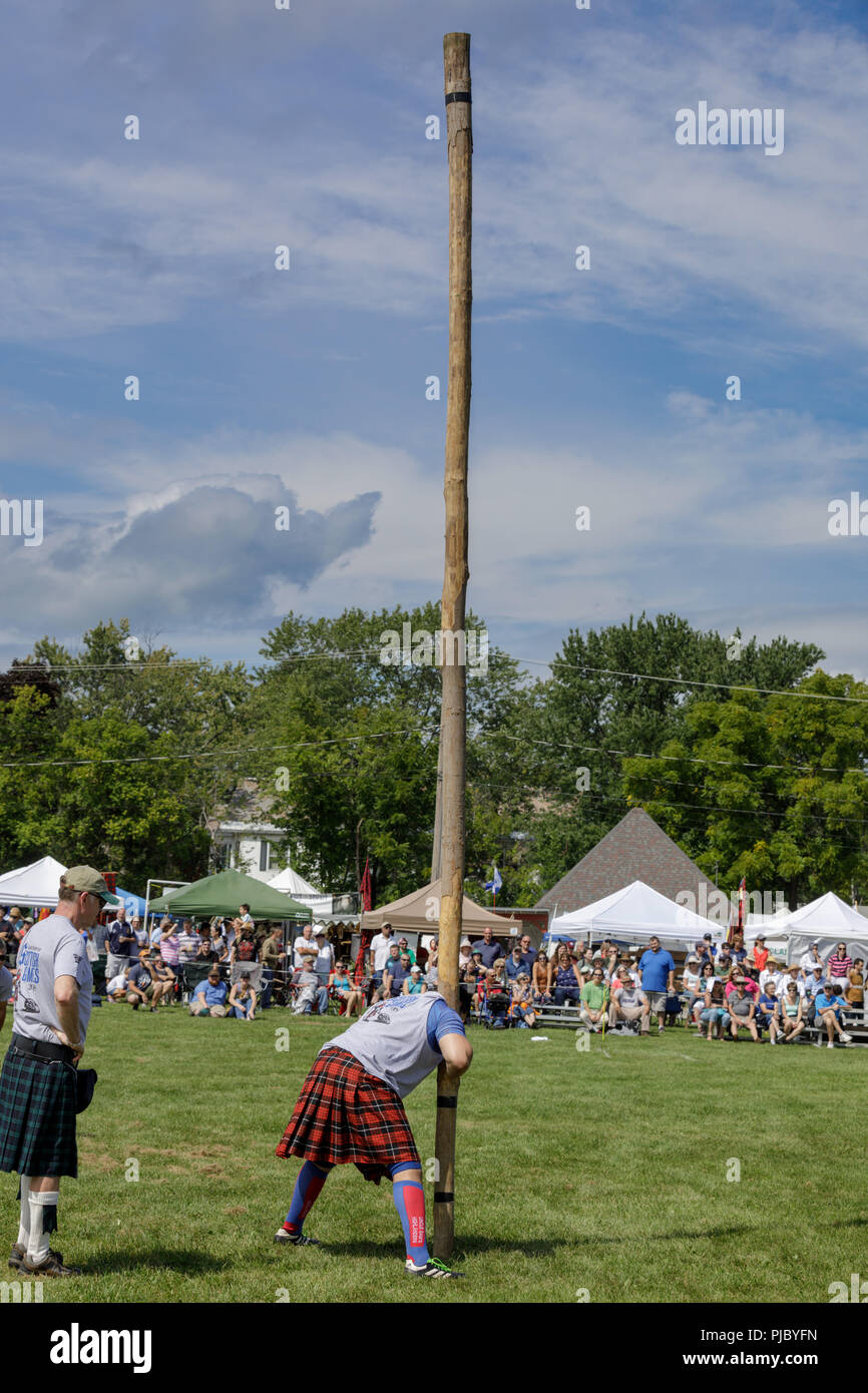 Man competes in the caber toss at the annual Capital District Scottish