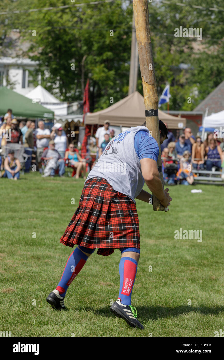 Man competes in the caber toss at the annual Capital District Scottish