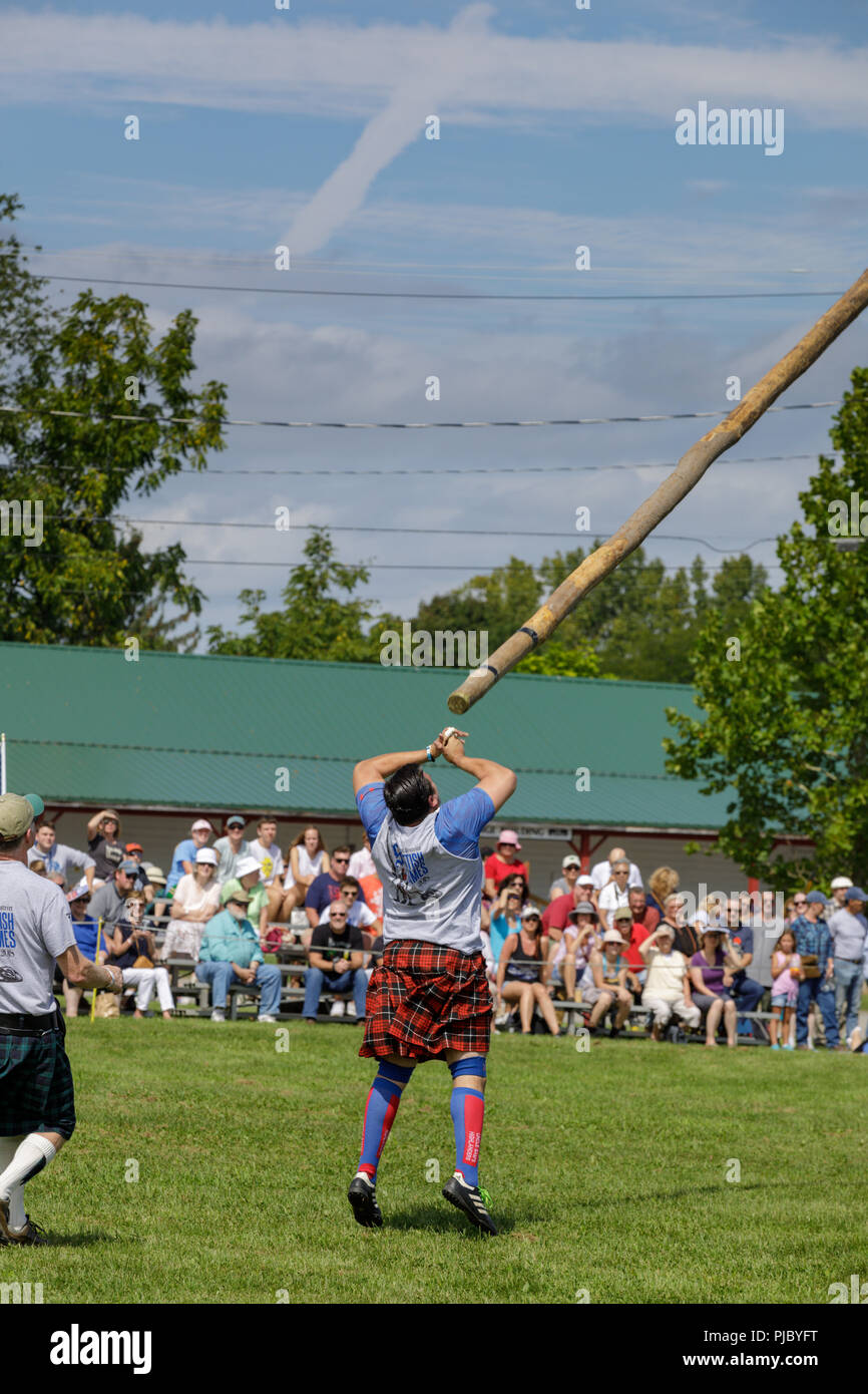 Man competes in the caber toss at the annual Capital District Scottish ...