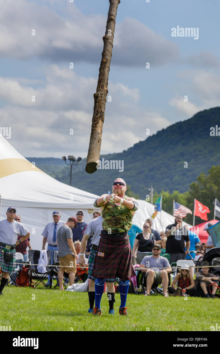 Man competes in the caber toss at the annual Capital District Scottish