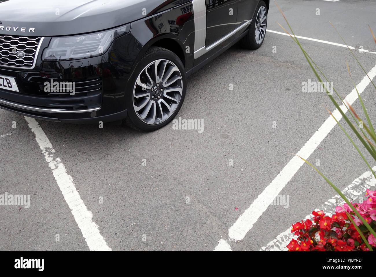 Range Rover Bad Parking in parking bay Stock Photo