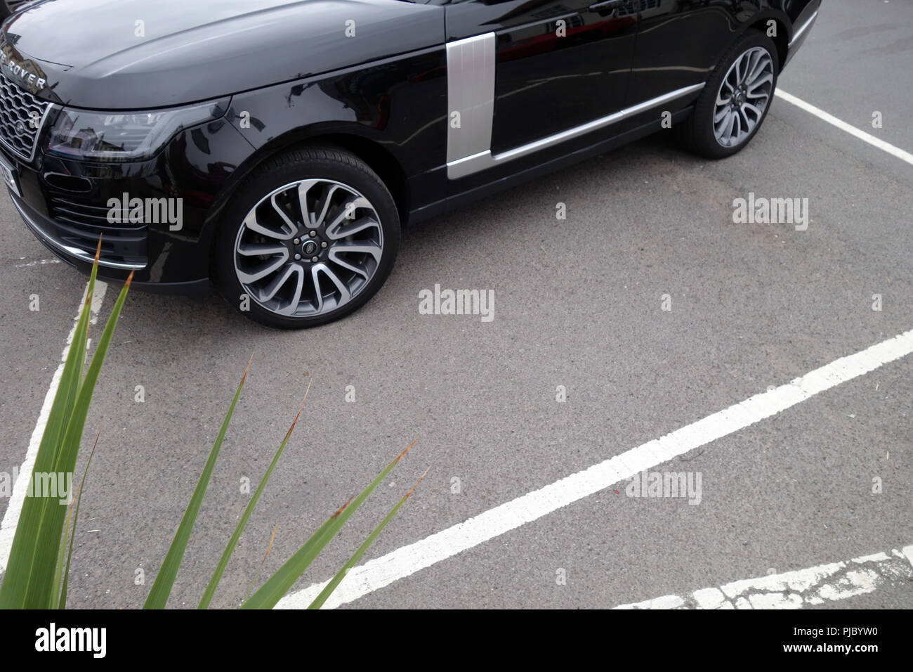 Badly Parked Range Rover in parking bay Stock Photo
