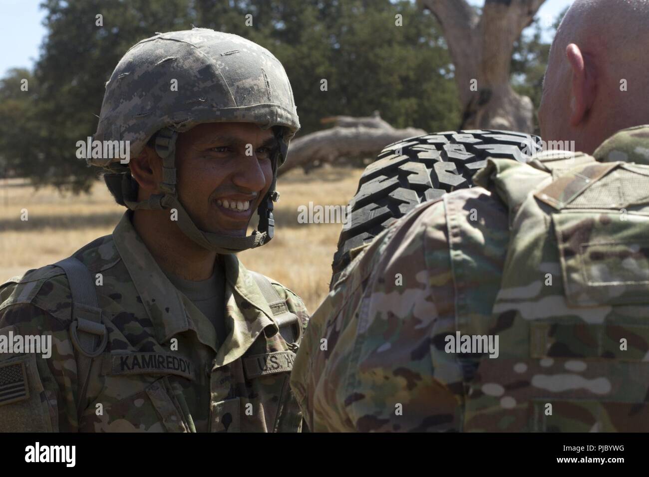 FORT HUNTER LIGGETT-- U.S. Army Reserve Lt. Gen. Charles D. Luckey (right) speaks with Spc. Srinivas Kamireddy while visiting training sites during the 91st Training Division's Combat Support Training Exercise on Ft. Hunter Liggett, California, July 17, 2018. The CSTX 91-18-01 ensures America’s Army Reserve units are trained to deploy bringing capable, combat-ready, and lethal firepower in support of the Army and our joint partners anywhere in the world. Stock Photo