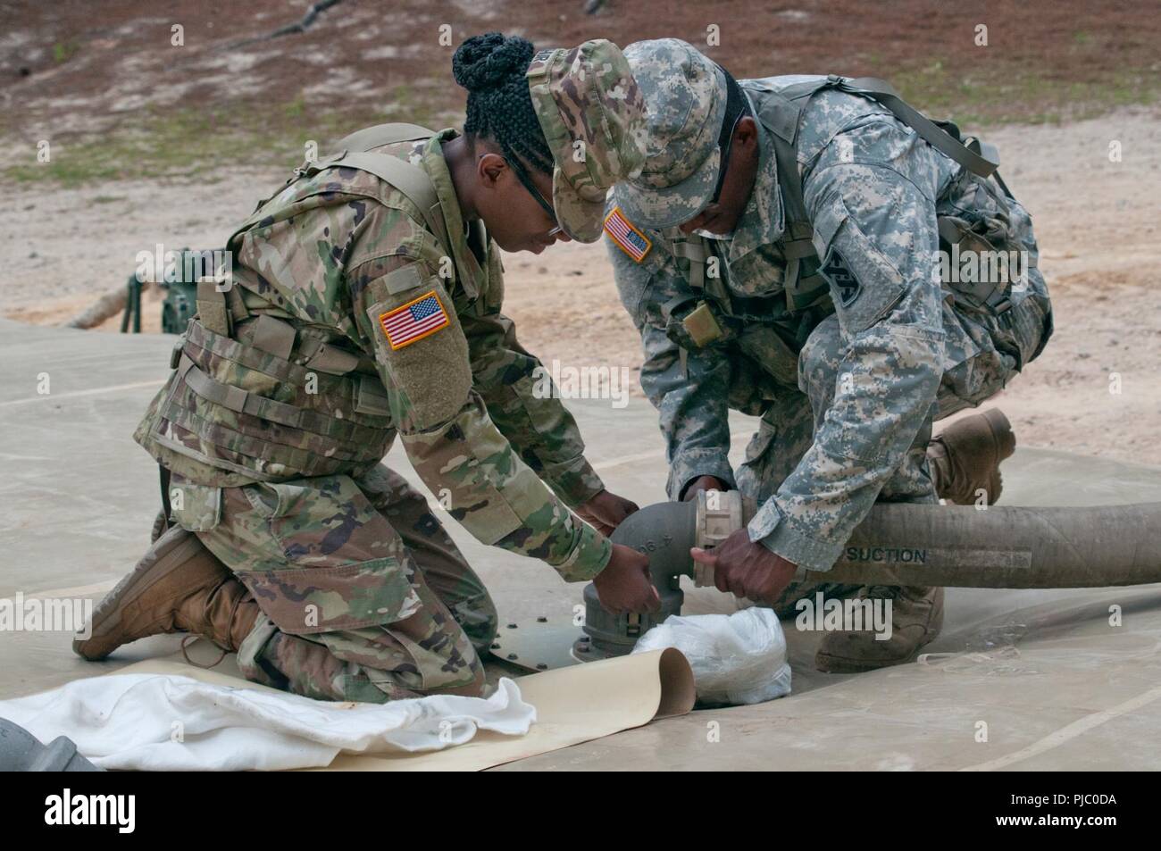 U.S. Army Reserve Soldiers, Pfc. Tkieya Arthur and Spc. Thomas Watkins,  92W, water treatment specialists, with the 431st Water Treatment Detachment  based in Winterville, North Carolina ensure a proper seal on the