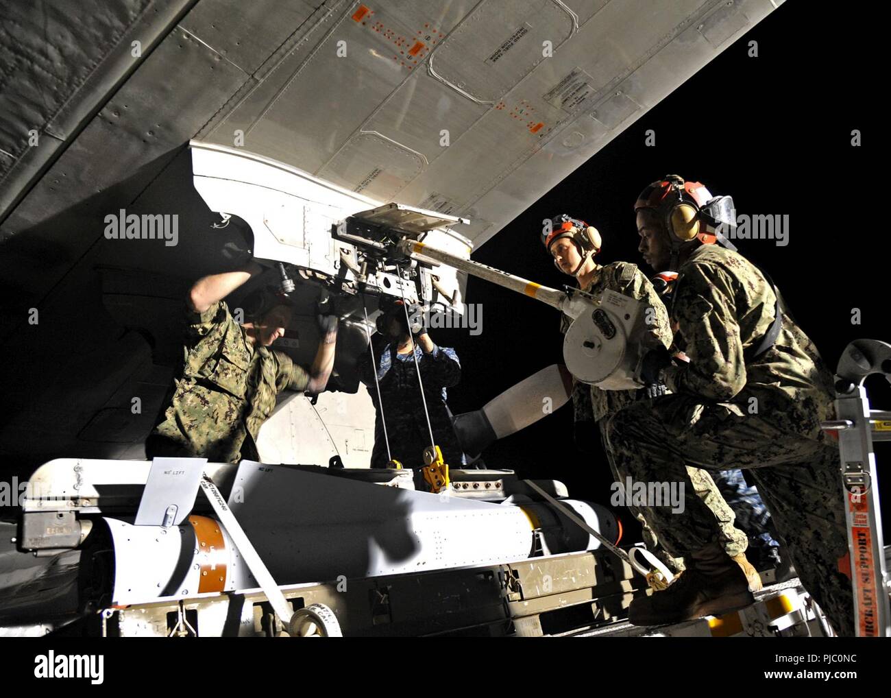 MARINE CORPS BASE HAWAII (July 19, 2018) — Sailors assigned to the 'Grey Knights' of Patrol Squadron (VP) 46, the 'Broad Arrows' of VP-62, and the 'Totems' of VP-69 load a AGM-65 Maverick missile onto a P-3C Orion aircraft on board Marine Corps Base Hawaii during Rim of the Pacific (RIMPAC) exercise, July 19. Twenty-five nations, 46 ships, five submarines, about 200 aircraft, and 25,000 personnel are participating in RIMPAC from June 27 to Aug. 2 in and around the Hawaiian Islands and Southern California. The world’s largest international maritime exercise, RIMPAC provides a unique training op Stock Photo