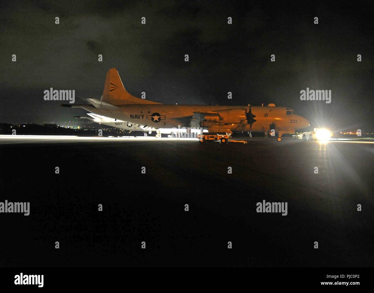 MARINE CORPS BASE HAWAII (July 19, 2018) —Sailors assigned to the 'Grey Knights' of Patrol Squadron (VP) 46, the 'Broad Arrows' of VP-62, and the 'Totems' of VP-69 load a AGM-65 Maverick missile onto a P-3C Orion aircraft on board Marine Corps Base Hawaii during Rim of the Pacific (RIMPAC) exercise, July 19. Twenty-five nations, 46 ships, five submarines, about 200 aircraft, and 25,000 personnel are participating in RIMPAC from June 27 to Aug. 2 in and around the Hawaiian Islands and Southern California. The world’s largest international maritime exercise, RIMPAC provides a unique training opp Stock Photo