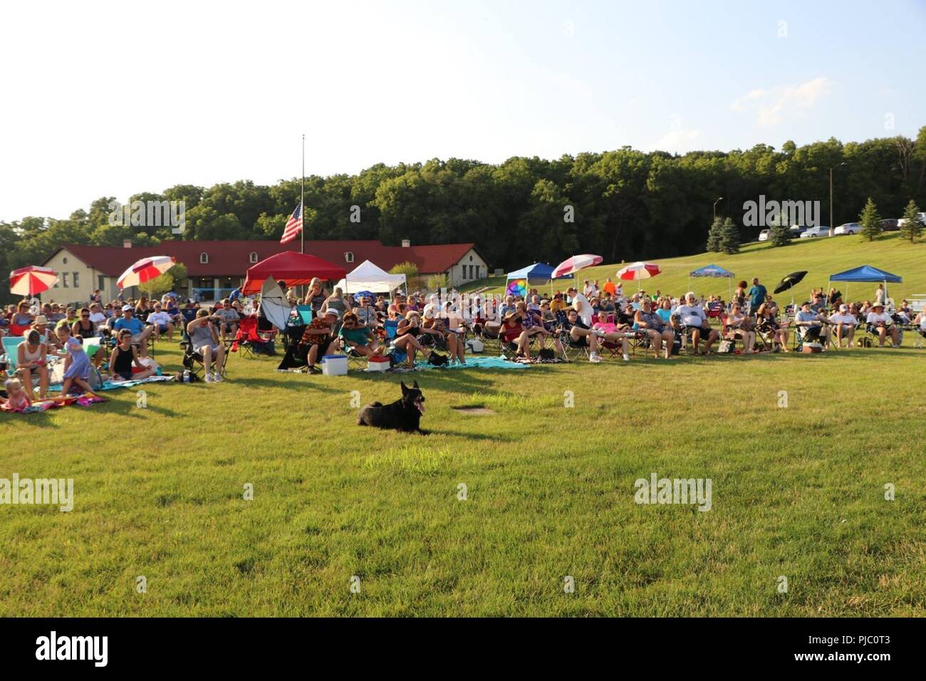 Concert goers wait for the band Abby Normal to kick off their performance at the 2018 Adjutant General’s Summer Concert Series at Camp Dodge Joint Maneuver Training Center in Johnston, Iowa, on July 12, 2018. The concert series is wrapping up its eighth year of free weekly concerts. Stock Photo